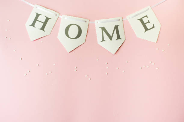 istock Word home on pastel pink background, top view with copy space . Family concept 1147032421