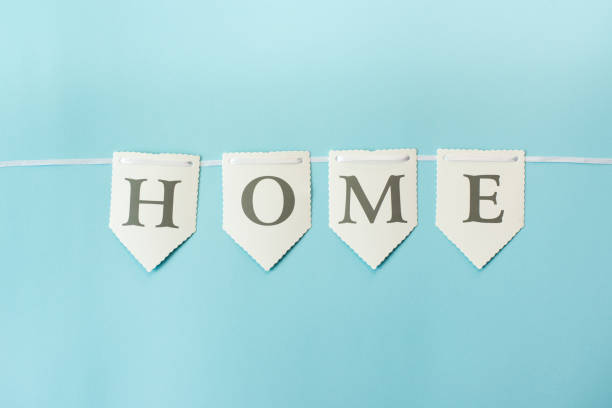 istock Word home on pastel blue background, top view with copy space . Family concept 1147032433