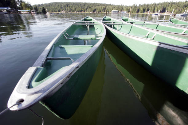 Portrait of a young woman relaxing in a canoe on a lake in nature