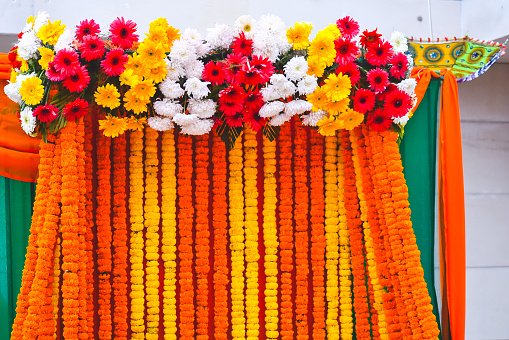 Tent decoration with cloth at a wedding ceremony with umbrellas, glass work, flower balls, and beautiful colorful cloth