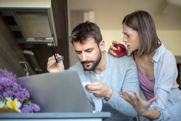 istock Couple paying bills online on laptop 1147035422