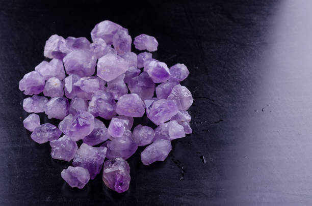 Amethyst Stones on a black background Amethyst Stones on a black background close up. Gemmary stock pictures, royalty-free photos & images