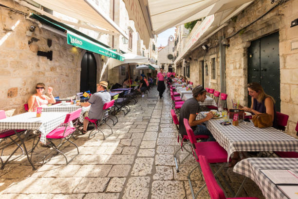 Dubrovnik, Croatia - 24th September 2017: Street restaurant old Dubrovnik. The city is considering limiting the number of cruise ships due to overcrowding.