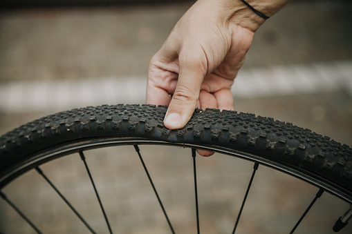 Finger crushed flat tire of a modern bicycle wheel
