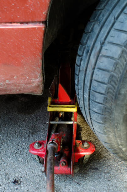 istock old red jack under car on street 1147043598