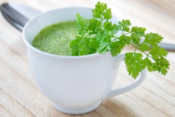 Green vegetables soup with broccoli and chervil close up