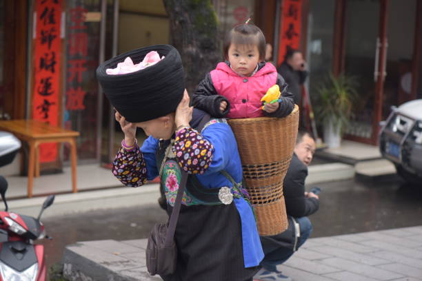 Asian mother with kids shopping in market fresh foods