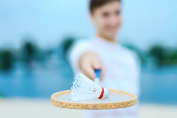 istock Young couple in love playing in badminton 1147056651