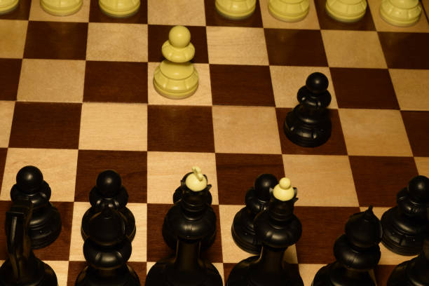 istock Wooden chess board and white pieces as a hobby background 1147060762