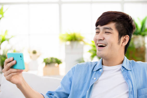 istock man watch video with phone 1147061493