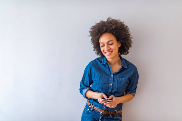istock Young woman holding smart phone. 1147061897