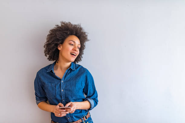 istock Young woman holding smart phone. 1147061899