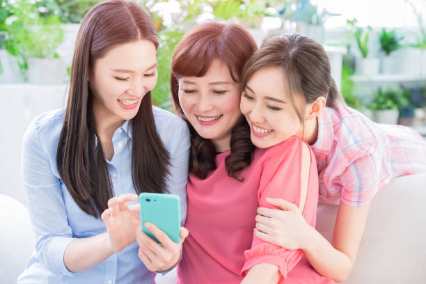 istock Daughters and mother use smartphone 1147063066