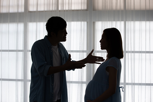 silhouette of pregnant couple arguing and quarreling at home