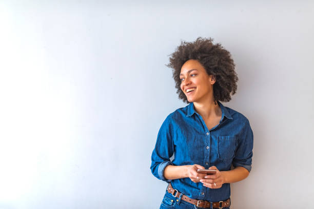 istock Young woman holding smart phone. 1147063490