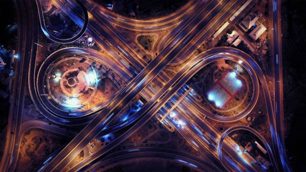 aerial view of highway junctions. bridge roads shape number 8 or infinity sign in structure of architecture concept. top view. urban city, bangkok at night, thailand. - road top view imagens e fotografias de stock