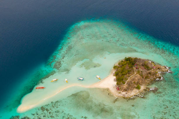 istock Small island with sand spit and coral reef 1147066430