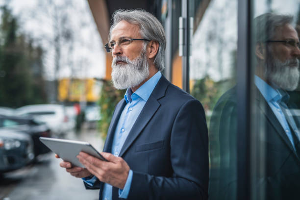 istock Caucasian senior businessman using a digital tablet outside his hotel 1147066548