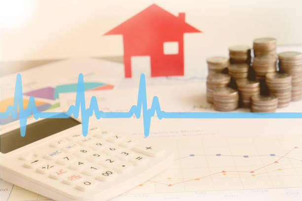 istock With House Model And Stack Of Coins On Desk 1147066600