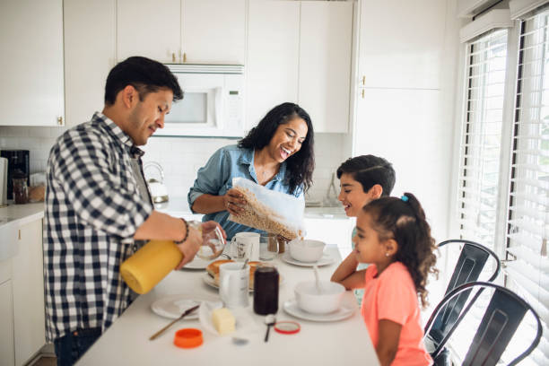 istock Hispanic family with two children eating breakfast in the kitchen 1147066700