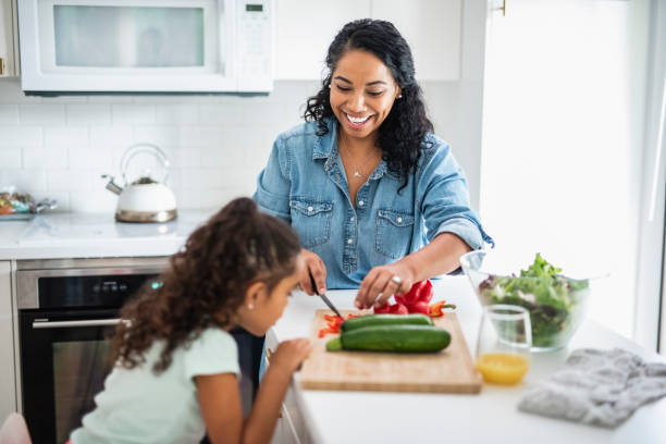 istock Mother and daughter preparing vegetables for lunch in the kitchen 1147066729