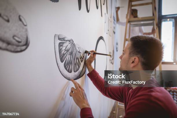 Handsome Artist Painting On The Wall Stock Photo - Download Image Now - Mural, Painting - Activity, Painting - Art Product