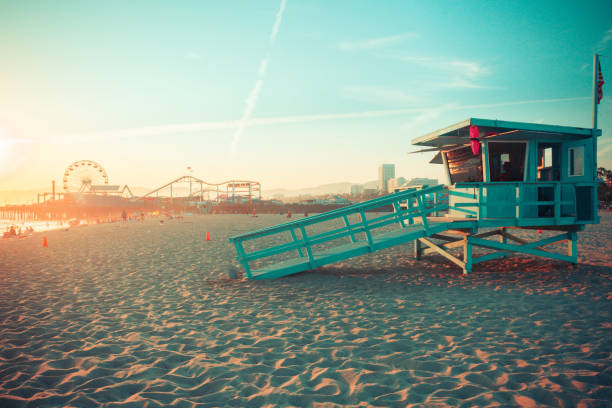 Iconic Santa Monica rescue cabin against famous amusement park in sunset Iconic Santa Monica rescue cabin against famous amusement park in sunset light southern california photos stock pictures, royalty-free photos & images