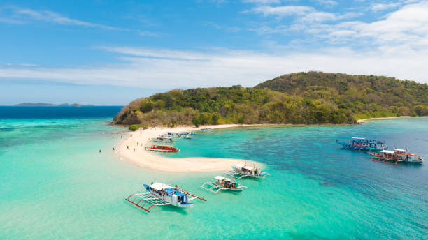 istock Boats with tourists on the white beach 1147068131