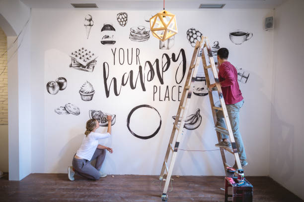 istock Couple of painters working on a white wall 1147068439