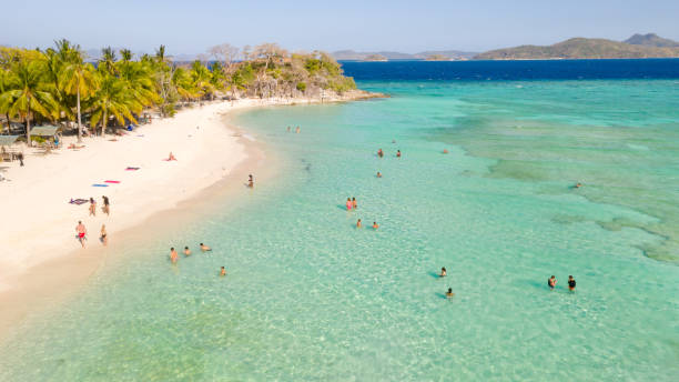 istock Lagoon with a white beach. Tourists relax on the beach 1147069278
