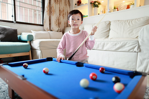 Portrait Of Boy Playing Snooker