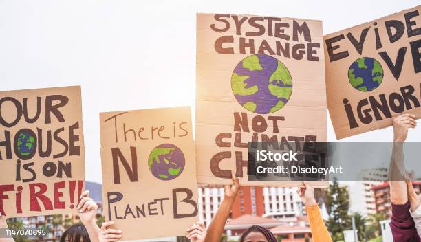 Group Of Demonstrators On Road Young People From Different Culture And Race Fight For Climate Change Global Warming And Enviroment Concept Focus On Banners Stock Photo - Download Image Now