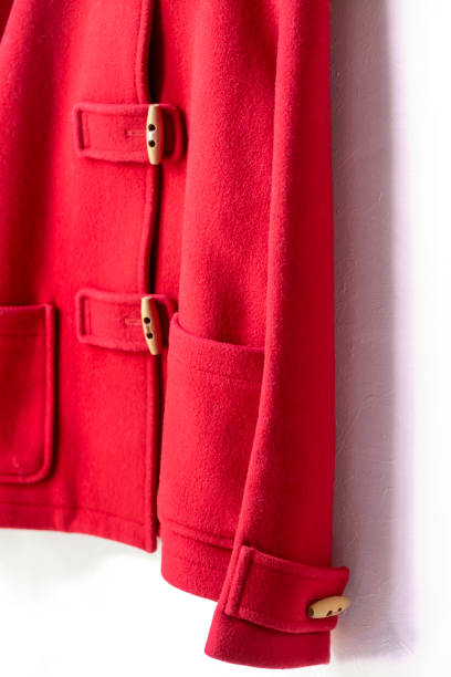 istock red wool coat hanging on clothes hanger on white background 1147077215