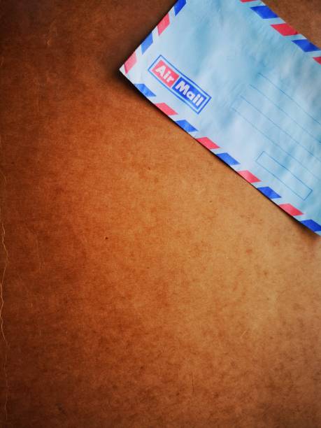 istock A vintage envelope airmail with wooden dark background. 1147079422
