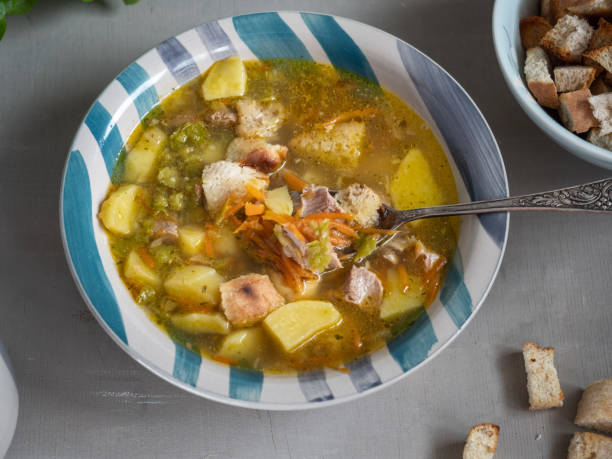 istock Pea soup in a deep ceramic plate with crackers and a tablespoon, nyato large planos from the top view. 1147079660
