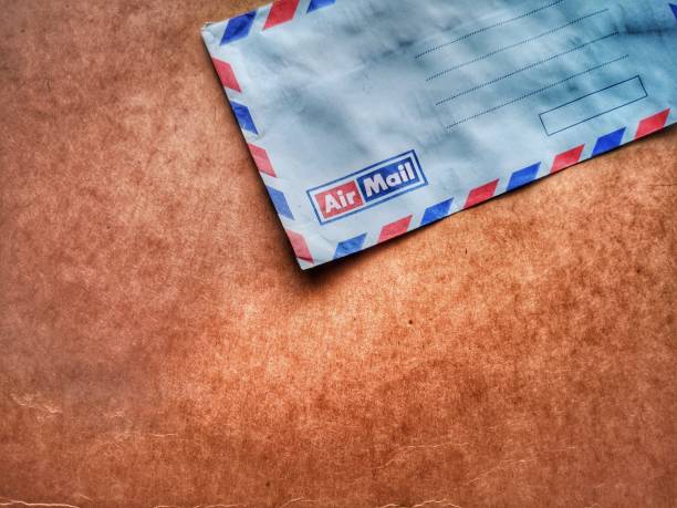 istock A vintage envelope airmail with wooden dark background. 1147081149