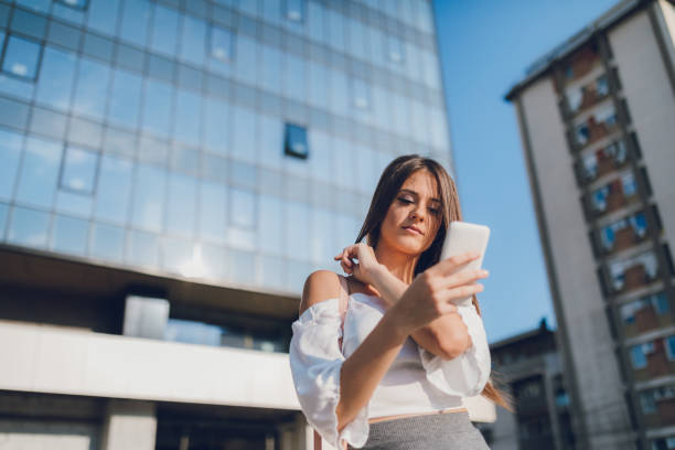 istock Businesswoman using phone downtown 1147082430