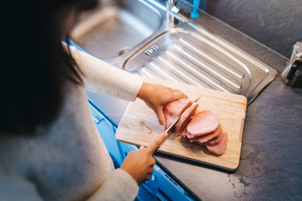 istock Woman cutting meat 1147083673