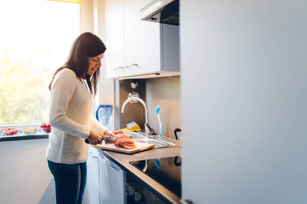 istock Woman cutting meat 1147083701