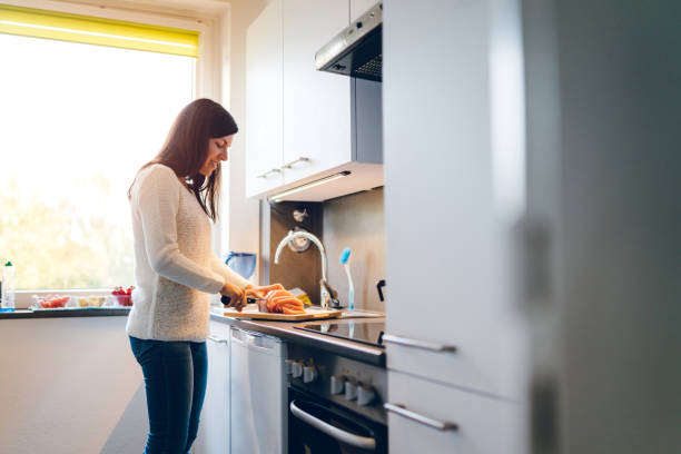 istock Woman cutting meat 1147083797