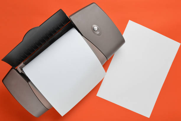 istock A printer with blank paper forms on a yellow background. Top view, flat lay. 1147086724