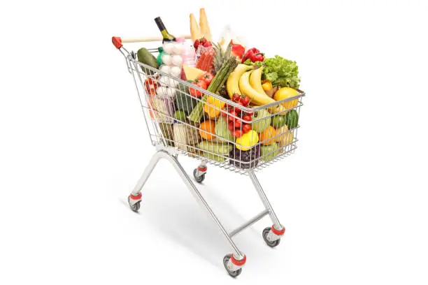 Shopping cart with different food products isolated on white background