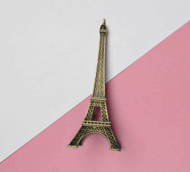 istock A souvenir statuette of the Eiffel Tower on a white pink pastel background. Top view. Minimalist trend. 1147086956