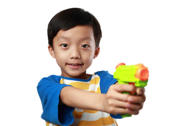 Japanese boy playing with water gun (first grade at elementary school)