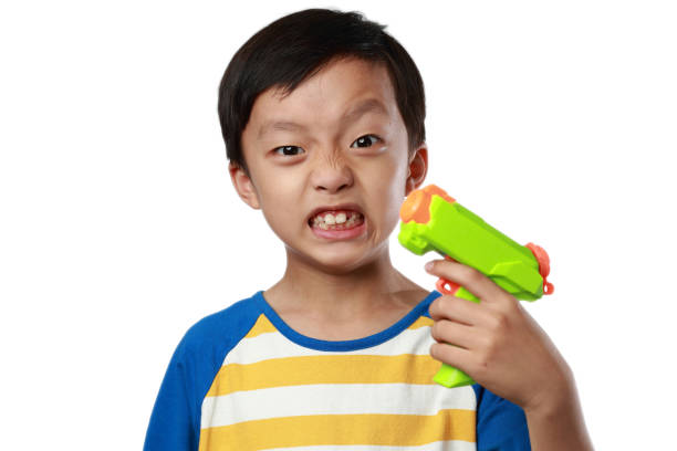 istock Children playing with toy guns 1147088421