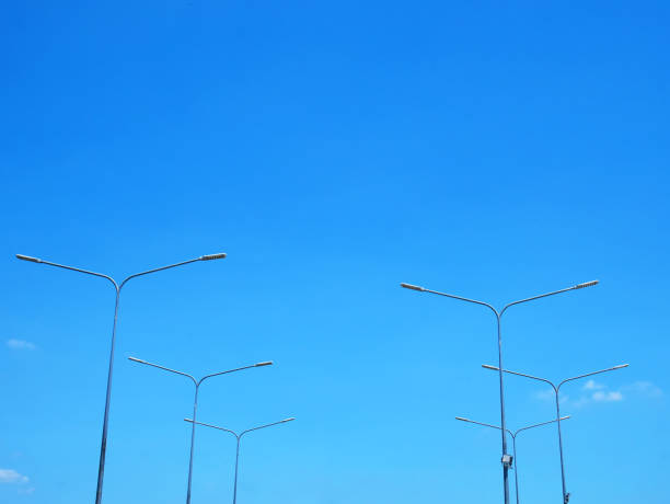 istock Low Angle View of Lamp Posts Against Blue Sky at Day Time 1147089344
