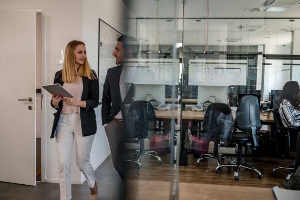 istock Business colleagues walking in the office 1147089415