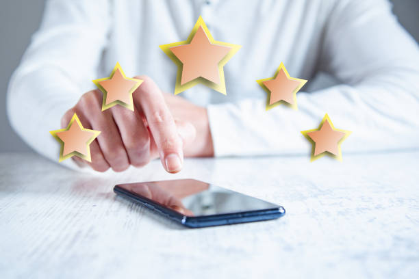 istock man hand phone with stars in screen 1147089536