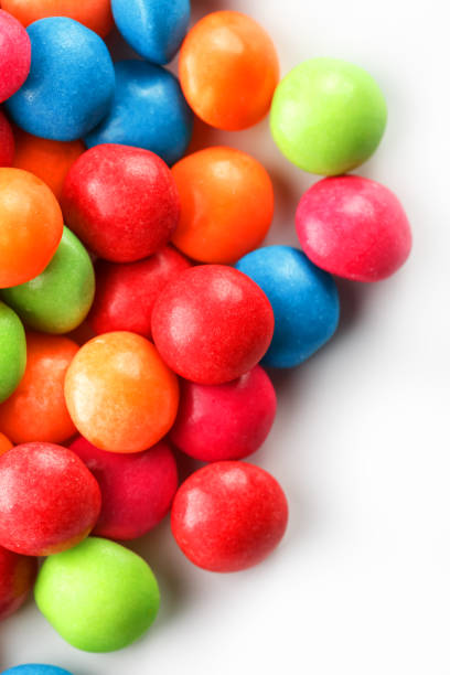 istock A rainbow of color from multicolored candies close-up, multi-colored glaze dragee on a white background 1147089565