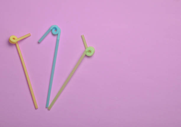 istock Colored cocktail tubes on a pink pastel background. Top view. Copy space. Minimalist trend. 1147090021